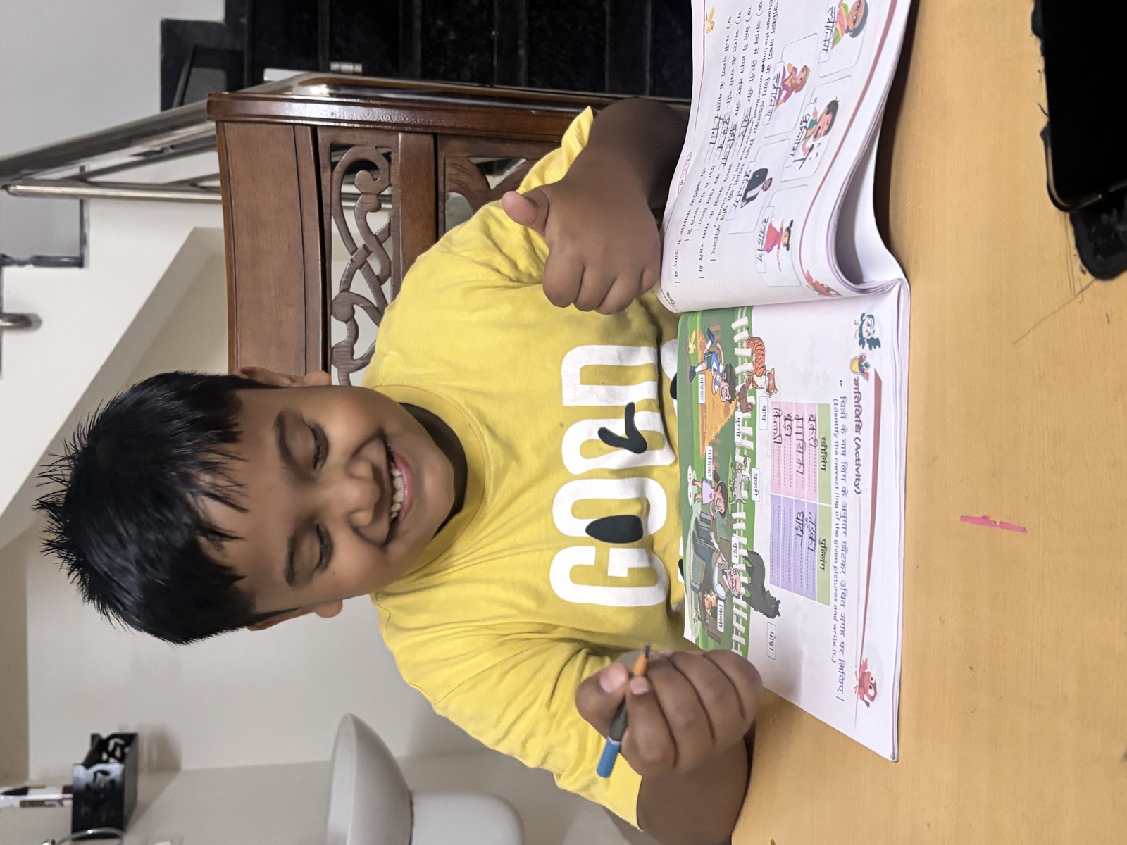 Garvit, a Learning Pod student happily doing homework at home