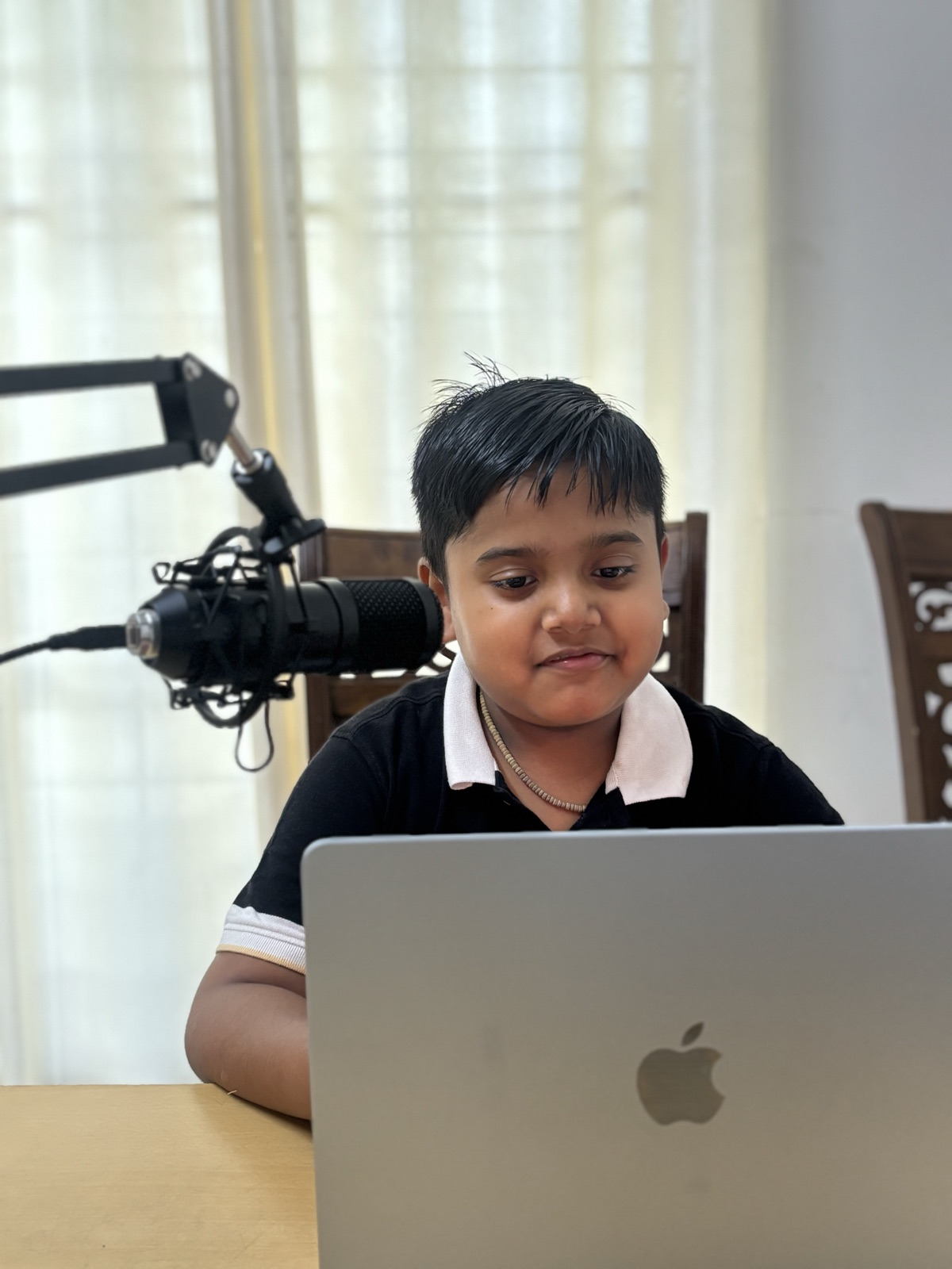 A Chennai student in an online class with a microphone